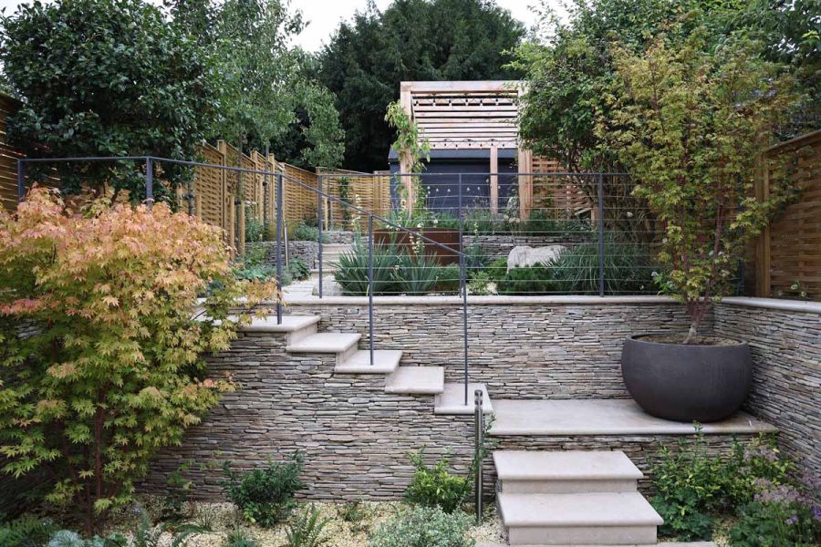 Elevated outdoor aesthetics with Jura Beige smooth limestone bullnose steps in a lush garden setting.