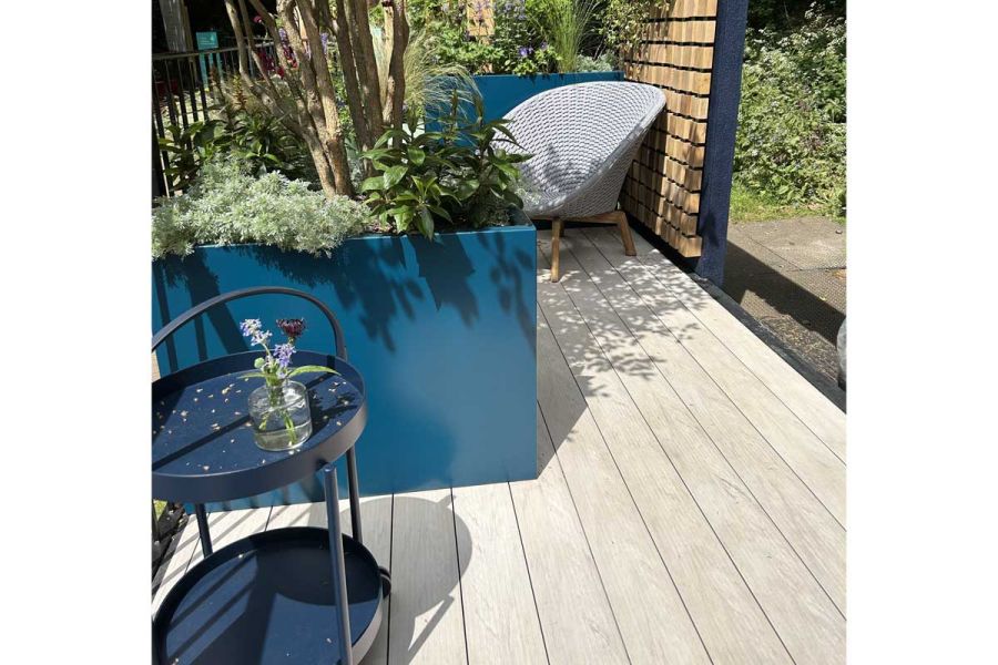 Blue drinks table and large planted troughs sit on Polar DesignBoard composite deck. RHS Chelsea design by Katherine Holland.
