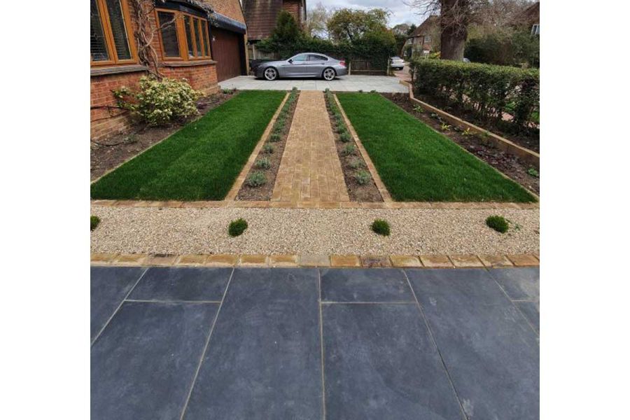London Mixture Clay Brick path divides lawn in half, connecting parking area to path in front garden designed by Landscape Artisan.