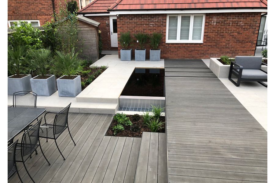 Back garden on 2 levels paved with Charcoal DesignBoard and Florence grey porcelain with cube planters and modern garden furniture.