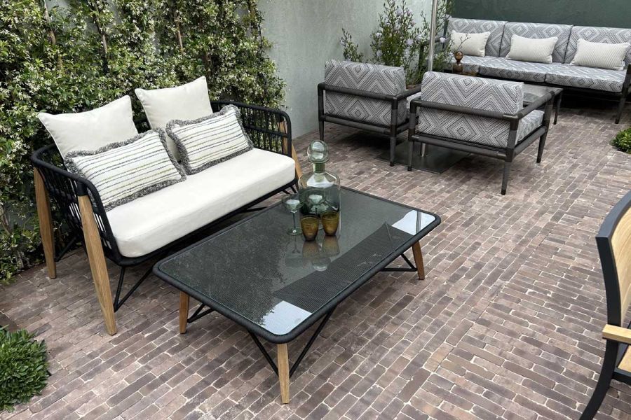 2 Indian Ocean furniture sets on Verona brick paving laid in 2 directions. Design by Max Parker Smith.