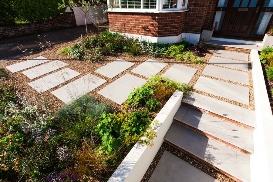 Front garden with Florence Grey slabs laid individually into gravel. Design by Jaki Grosvenor. Built by Nordland Landscapes.