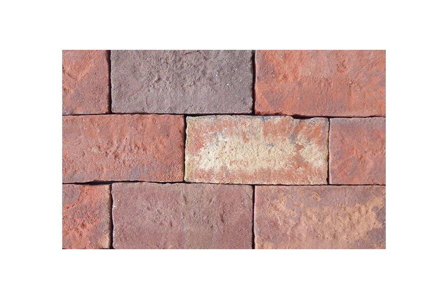 Close-up of Old English clay paver bricks laid in stretcher bond pattern without sanded joints, showing grey, white and pink tones.
