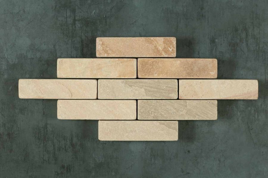 5 rows of 9 Mint sandstone patio bricks arranged in lozenge, showing pale markings on brick face. Free UK delivery available.
