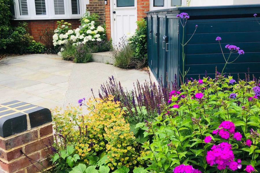 House front by Eve Hacking Landscape and Garden Design, with Kandla Grey Indian Sandstone paving , storage shed and white hydrangea.