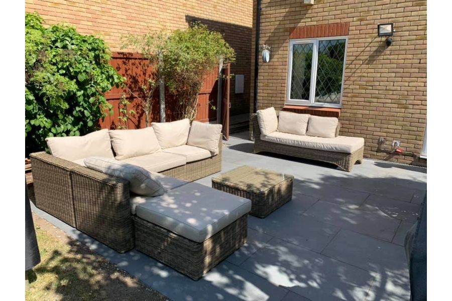 Platinum Grey Porcelain Paving Slabs in small garden for entertaining with rattan couches and table. Garden Tiles UK with free delivery.