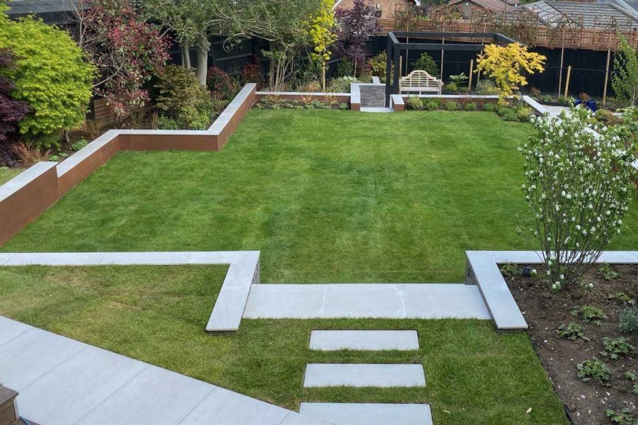 Large lawn outlined by retaining and boundary walls faced with Vintage Steel Premium DesignClad. Build by Praesto Landscapes.