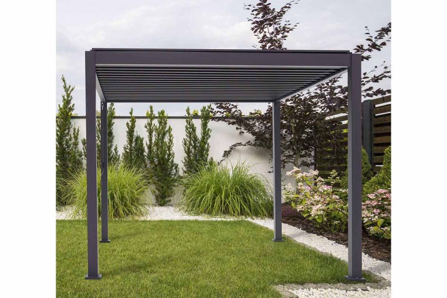 Proteus Grey Aluminium Pergola stands on grass in garden. Slim powder-coated aluminium legs support louvred flat roof. 