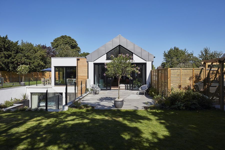 Large contemporary house with a Cinder porcelain patio and multi levelled garden area.