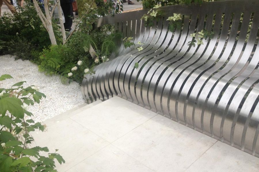 London Square garden by Jo Thompson for RHS Chelsea 2014. Sandy White Porcelain paving, steel curved bench, white planting scheme.