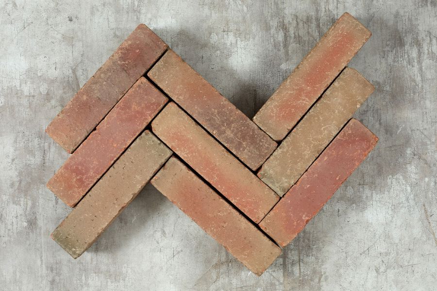 3 zigzag rows of red Seville Clay Pavers arranged on white background, showing colour variation. Free UK delivery available.