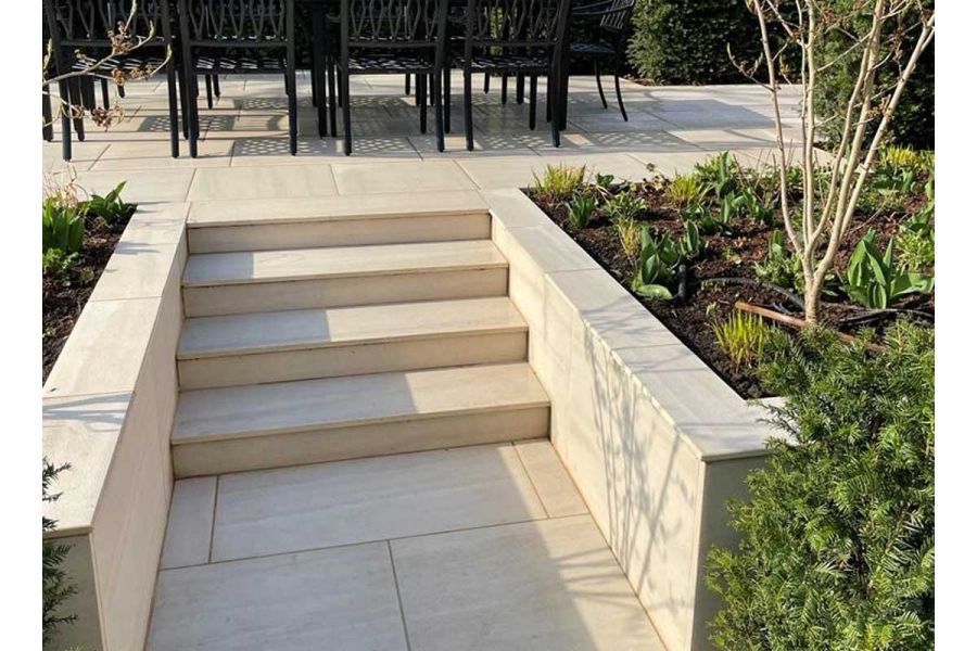 Faro Porcelain slabs for steps pave flight from matching path to patio between flanking walls. Design by Shoots and Leaves.