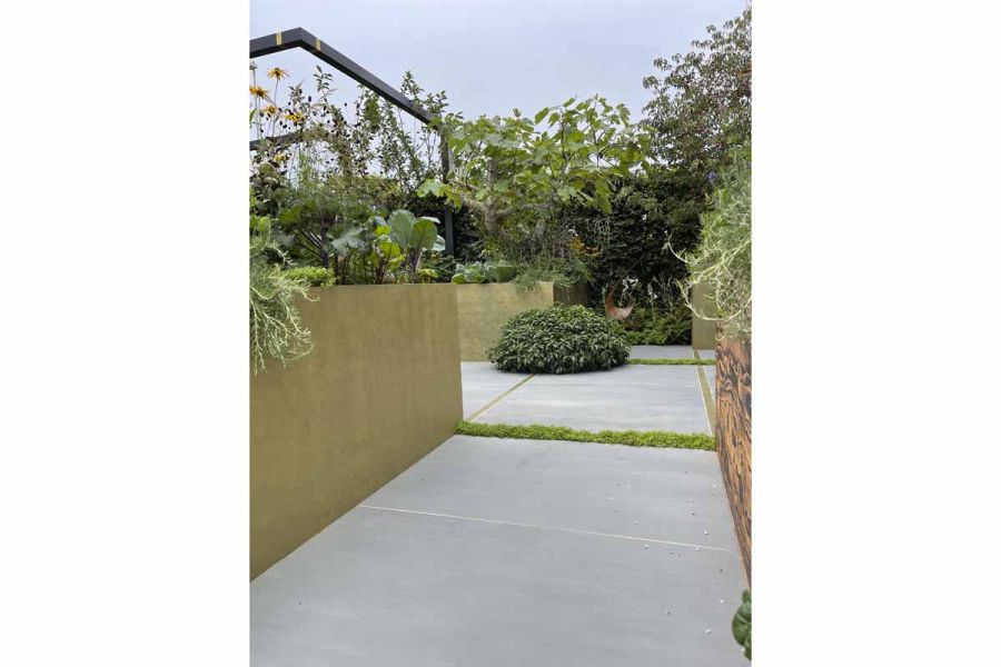 1200x1200 Sidewalk porcelain paving slabs laid in between two large planters and grouted with white grout.