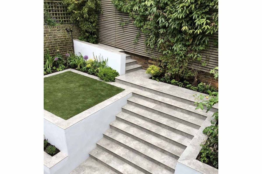 Flight of 8 20mm bullnosed Silver Contro Porcelain Paving Steps between white flank wall, up to narrow terrace in matching paving.