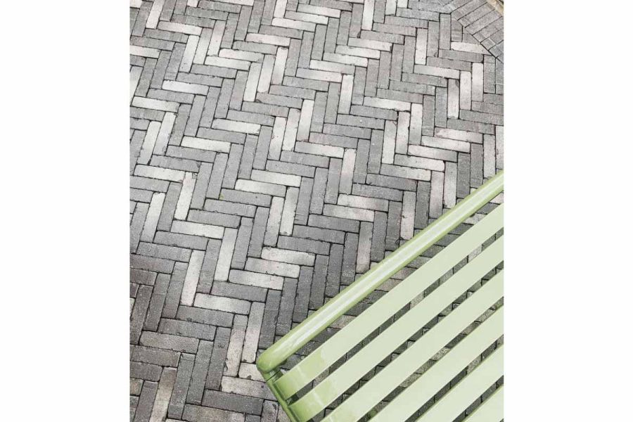 View down onto Silver Grey Multi clay pavers, laid herringbone fashion by Cadogan Landscapes, shows mix of light and dark tones.