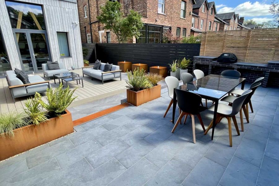 Urban outdoor space geared up for adult entertainment with Composite Decking and Slab Coke Porcelain patio.