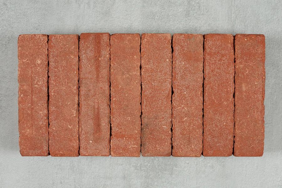 8 Spalding clay pavers laid close together on edge in row on pale background, showing smooth texture and markings.