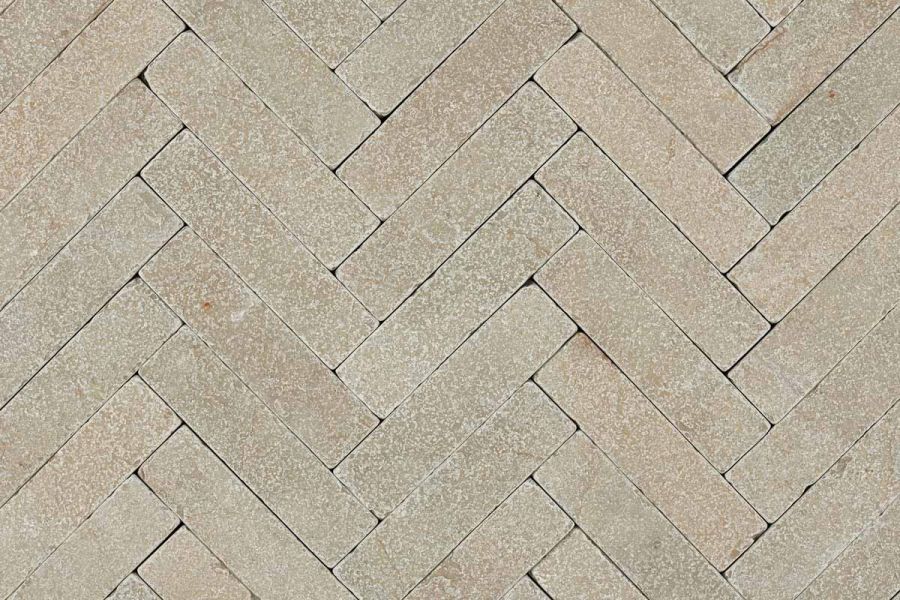 View directly down onto Antique Yellow limestone pavers laid in herringbone pattern without joints. Free UK delivery available.
