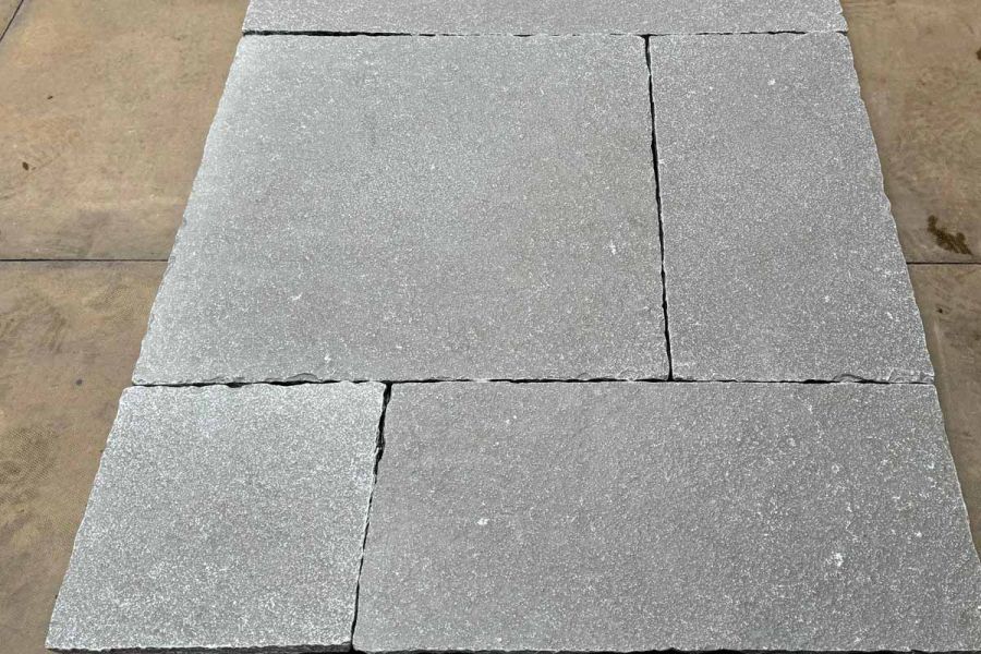 Close up shot showcasing the intricate texture and hand-crafted edges of Antique Grey Limestone paving.