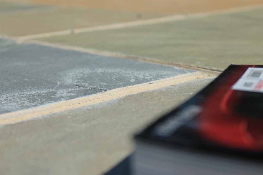 Ground-level close-up of Kota Brown limestone paving laid with wide joints and showing different colour tones.