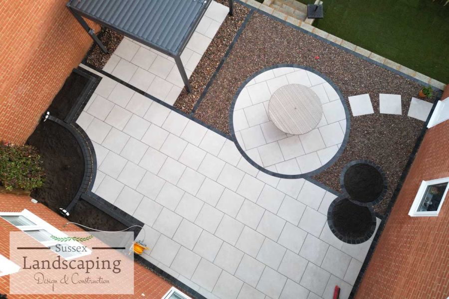 Aerial view of patio, with Florence Grey porcelain paving circle, patio and stepping stones. Design by Sussex Landscaping.