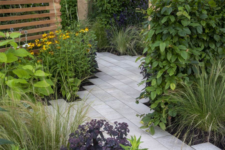 Cream porcelain plank paving laid with staggered ends in It's OK Not to BE OK, Tatton Park show garden 2021, by James Smith.