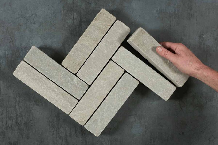 8 Kandla Grey tumbled sandstone stone pavers placed in pairs in interlocking pattern. Free UK delivery available.