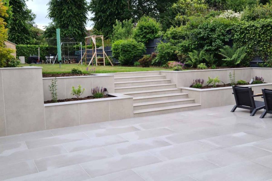 Modern garden scheme featuring Urban Grey Porcelain Paving, garden steps and pencil round copings, all supplied by London Stone.