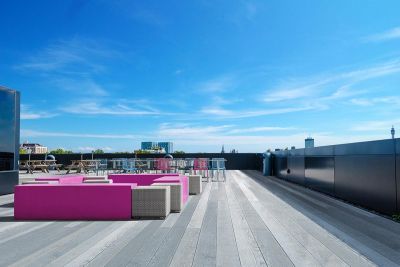 Large roof terrace laid with long planks of grey Enhanced Grain Decking. Various seating options are spread across the area.***