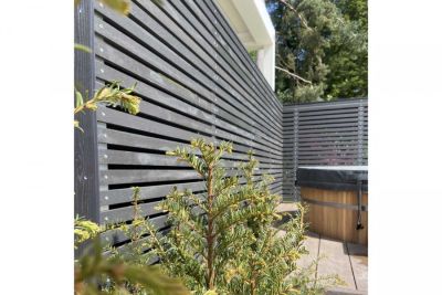Dark Ash composite battens used for long, tall screen to edged boarded outdoor area with yew. Designed by Thouvenin Landscapes.***Image also displays Millboard Burnt Cedar Fascia | Thouvenin Landscapes Ltd, www.thouveninlandscapes.com