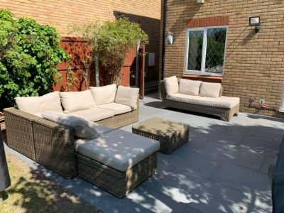 Platinum Grey Porcelain Paving Slabs in small garden for entertaining with rattan couches and table. Garden Tiles UK with free delivery.***Woods Paving,  www.woodspaving.co.uk