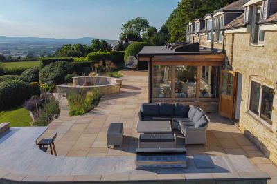 Terrace of Buff sawn sandstone garden paving  overlooking distant view at back of house. Built by Garden Solutions Stroud.***Image also displays Buff Steps | Garden Solutions Stroud Ltd, www.landscapinggloucestershire.co.uk
