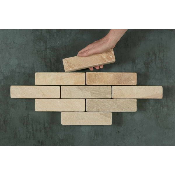 Hand adds 9th stone paver to 8 Mint sandstone patio bricks arranged in 4 rows in lozenge shape. Free UK delivery available.***