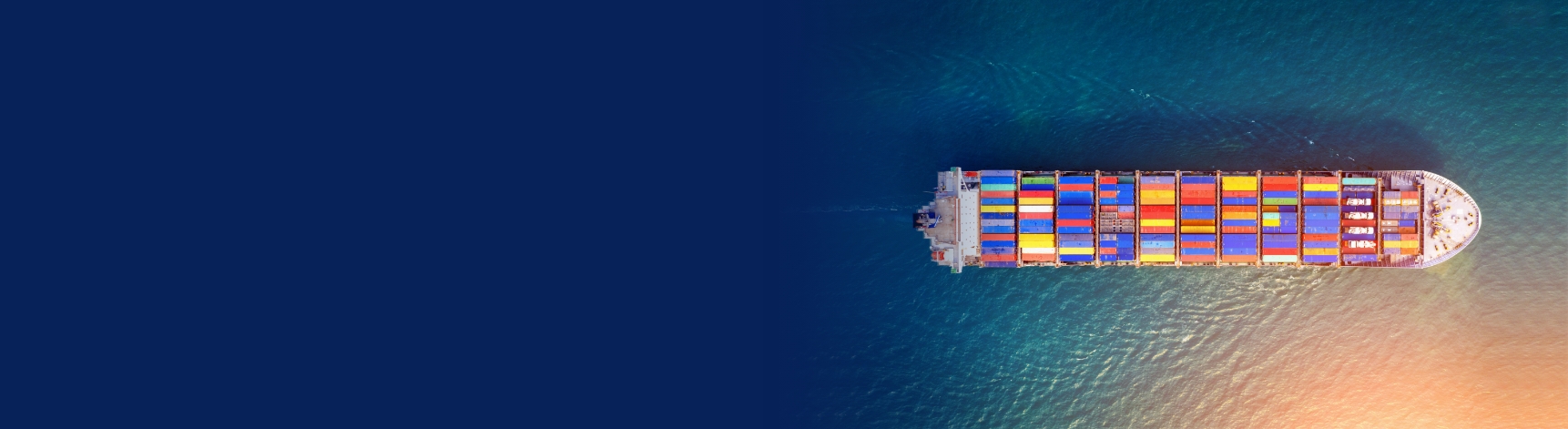 Container ship with multi-coloured cargo see from above, next to How did we calculate our carbon footprint.