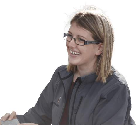 Young woman in glasses smiling and looking to left.