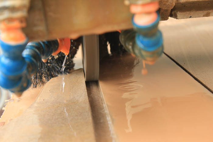 Calibrating wheel in action on natural stone paving. 