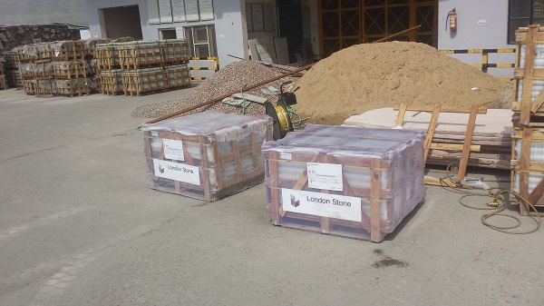2 wooden crates full of London Stone sandstone paving in supplier's yard.