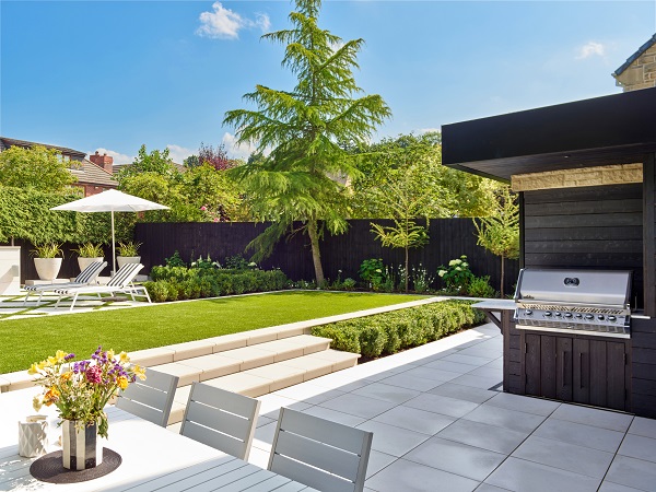 Comblanchien porcelain patio wrapped around corner of house, Wide steps up to lawn.