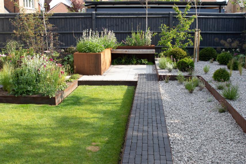 Rectilinear garden design with gravel lawn, corten steel planters and Amersham clay pavers.