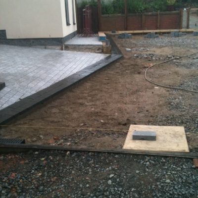 Area part laid with grey granite and black basalt setts