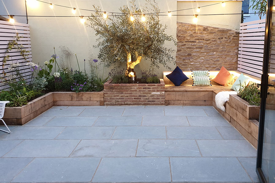 Courtyard garden paved with Kota Blue Limestone. Built-in bench seating and raised beds.
