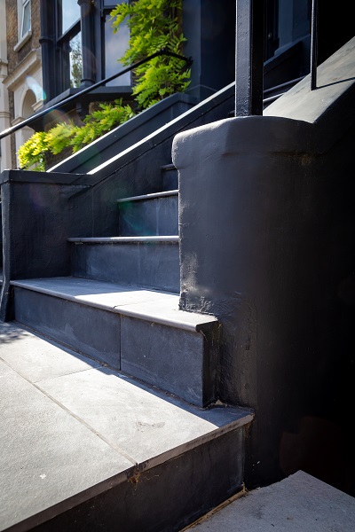 Flight of Florence Dark porcelain steps  with 20mm bullnose edge between flanking walls.