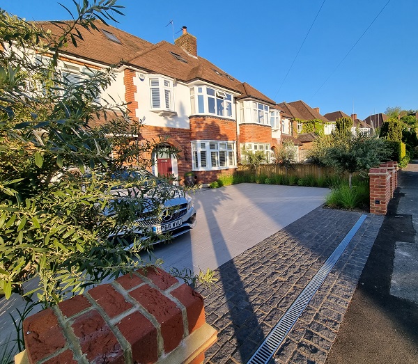Wide paved frontage to 1930s house, paved with Florence Grey porcelain with strip of black granite setts at entrance. 