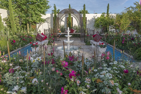 A turkish tent behind a travertine paved area with tiered fountain at RHS Hampton Court 2015.