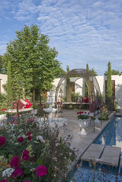 Rill with stepping stones to matching unfilled travertine paving in Garden of Paradise at RHS Hampton Court 2015.