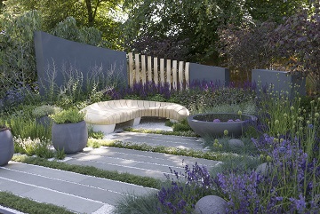 Rae Wilkinson show garden with Kota Blue limestone plank paving staggered in gravel between planting.