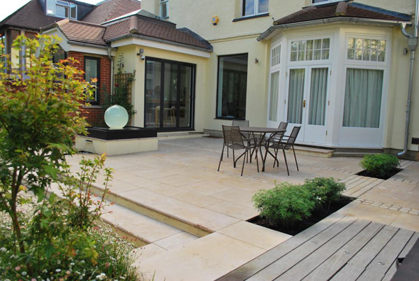 Jura Beige and Tumbled mint sett patio at back of cream-coloured Edwardian house.