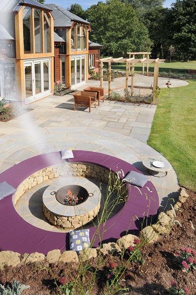 Firepit and sunken seating circle in wide patio by Graduate Landscapes