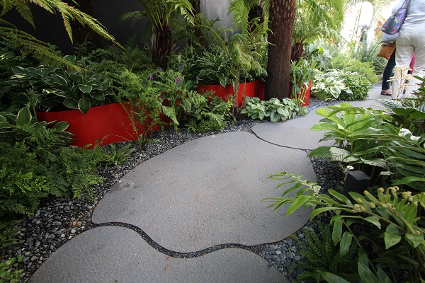 Large bespoke-cut sintered stone slabs laid in curved path  in Bowel Disease UK Garden, Hampton Court Flower Show 2016.