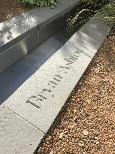 Grey Yorkstone Coping engraved with name edges stainless steel rill in Creative Roots' RHS Chatsworth show garden 2017.